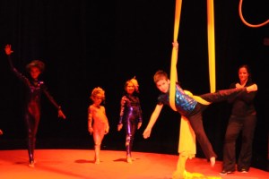 Young boy performing on circus silks