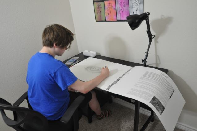 Kameron Badgers working in Jacob's sketchbook for the film Beyond the Bridge