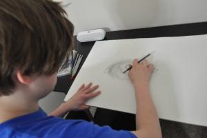 Kameron Badgers working in Jacob's sketchbook for the film Beyond the Bridge